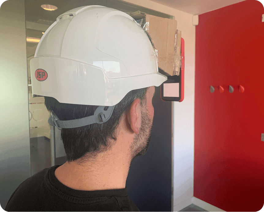 An early prototype rig taped to a hard hat to test how the display would sit in front of the eye